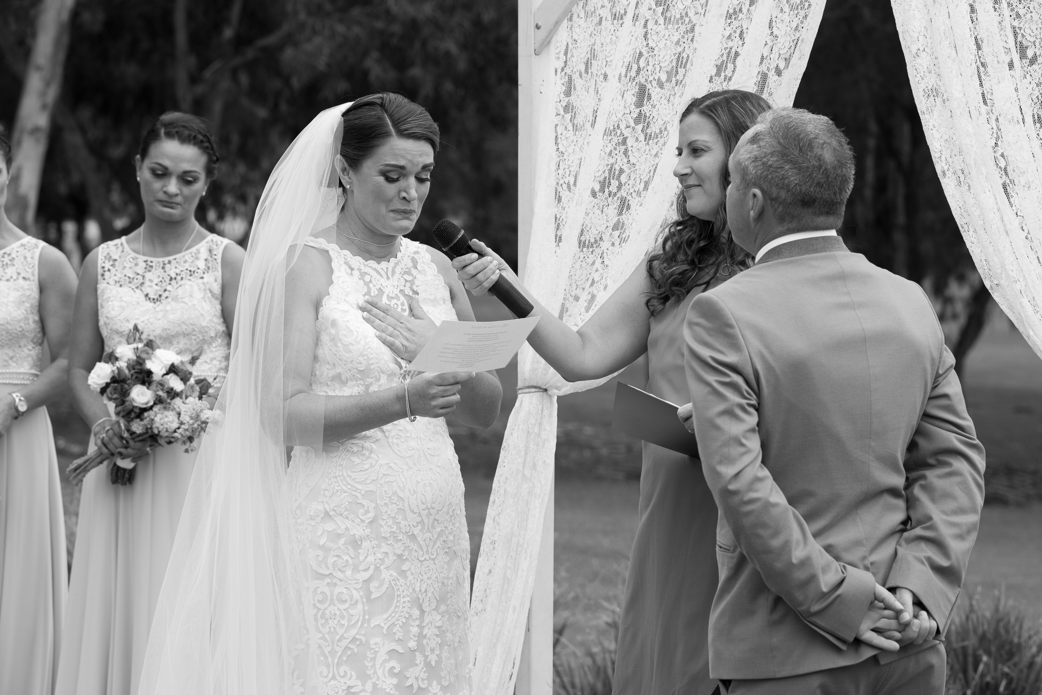 bride takes a moment during her vows feeling emotional