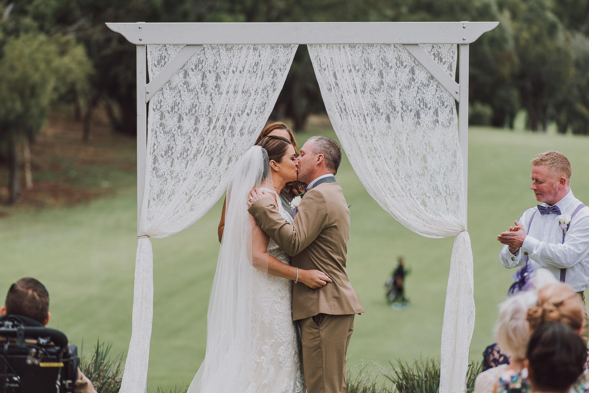 bride and groom kiss at wedding at Point Walter golf course