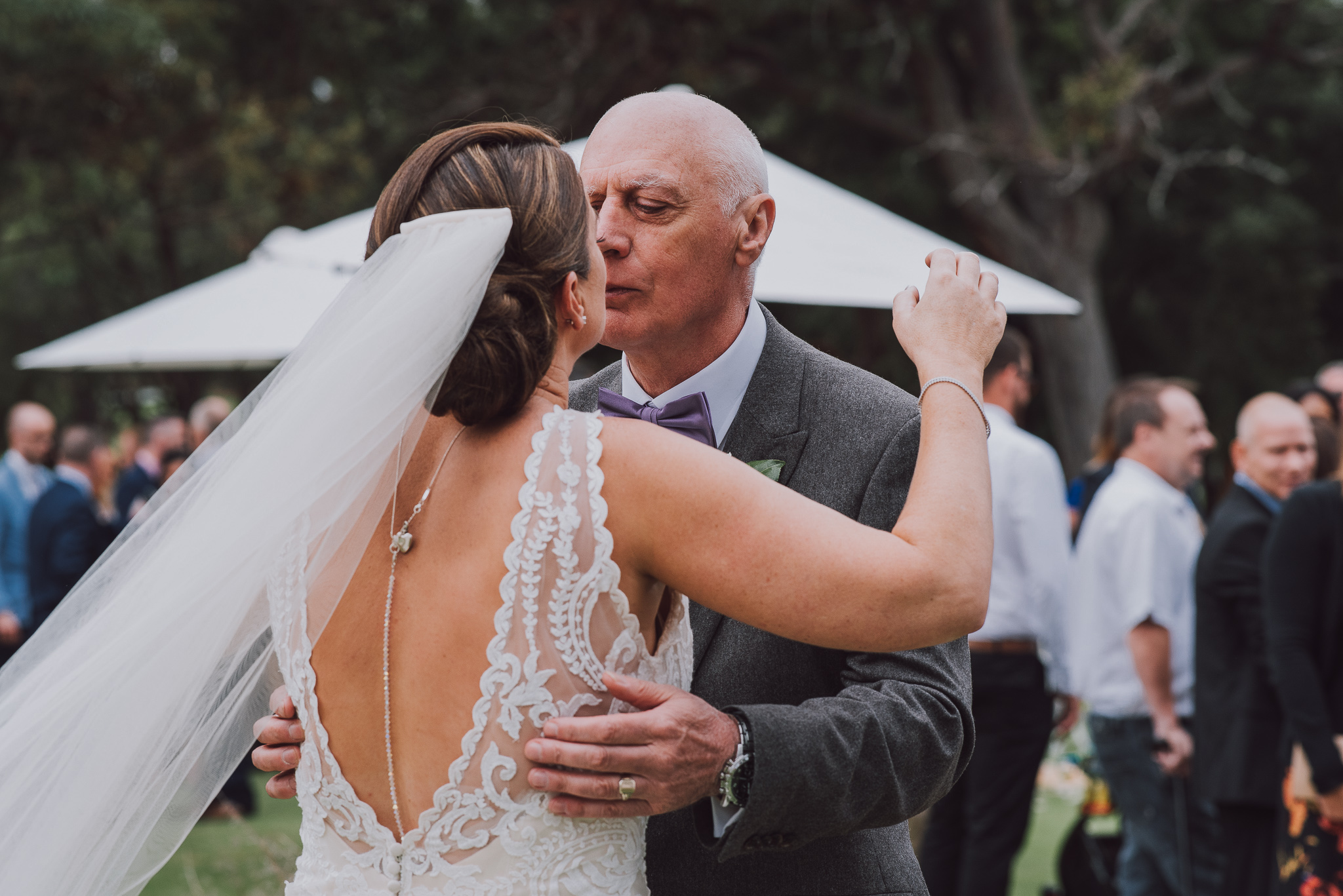 bride and her dad kiss after ceremony