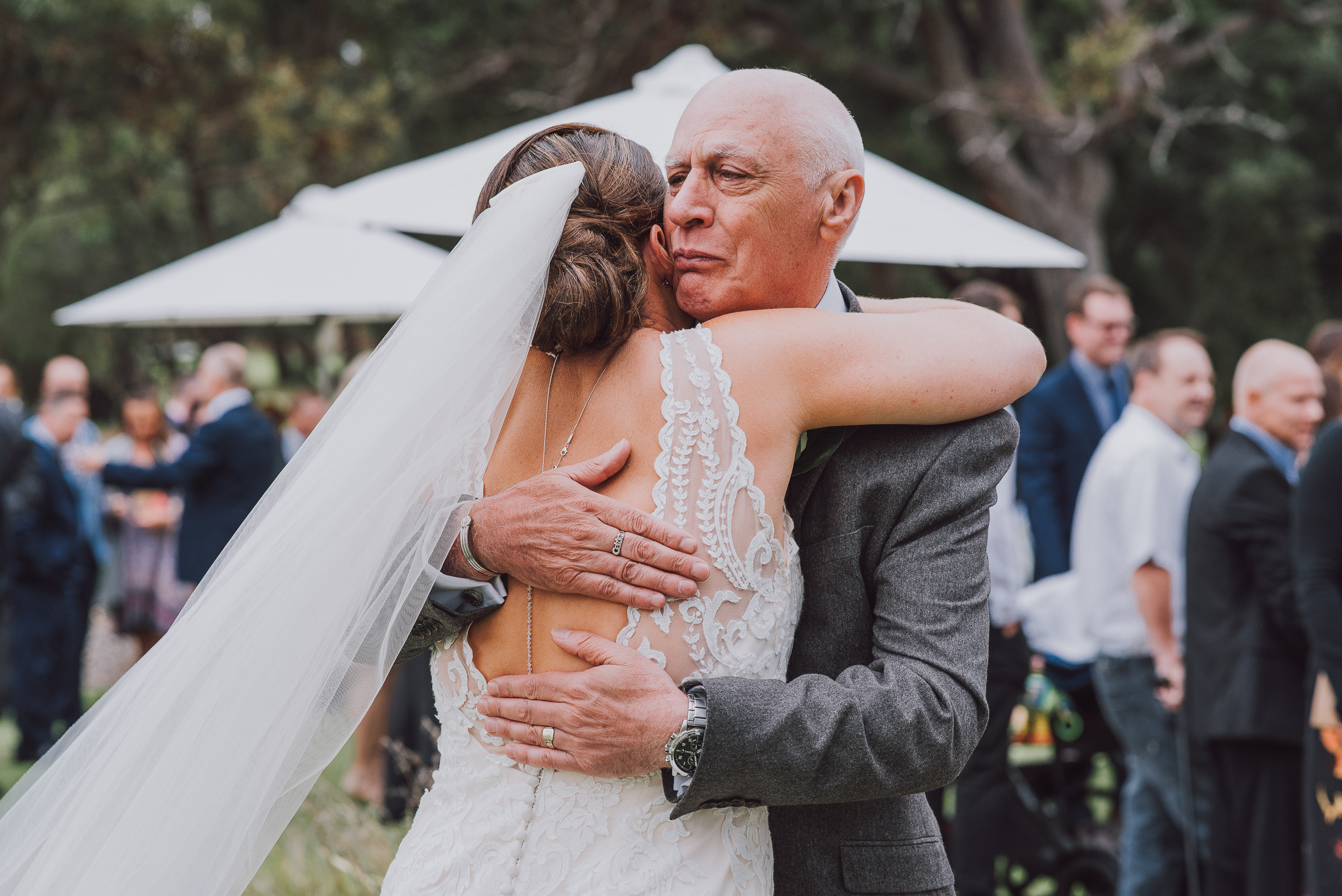 bride and her dad hugs after wedding ceremony