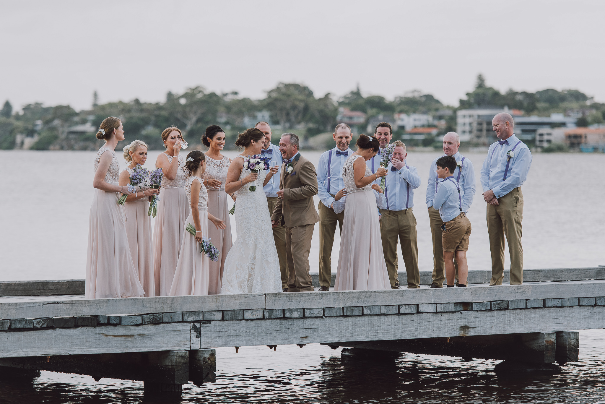 bridal party hanging out on the pier