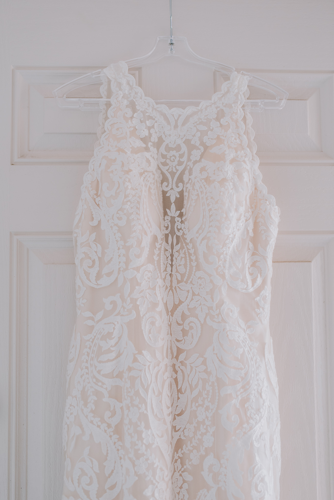 close up of bride's dress hanging on hanger