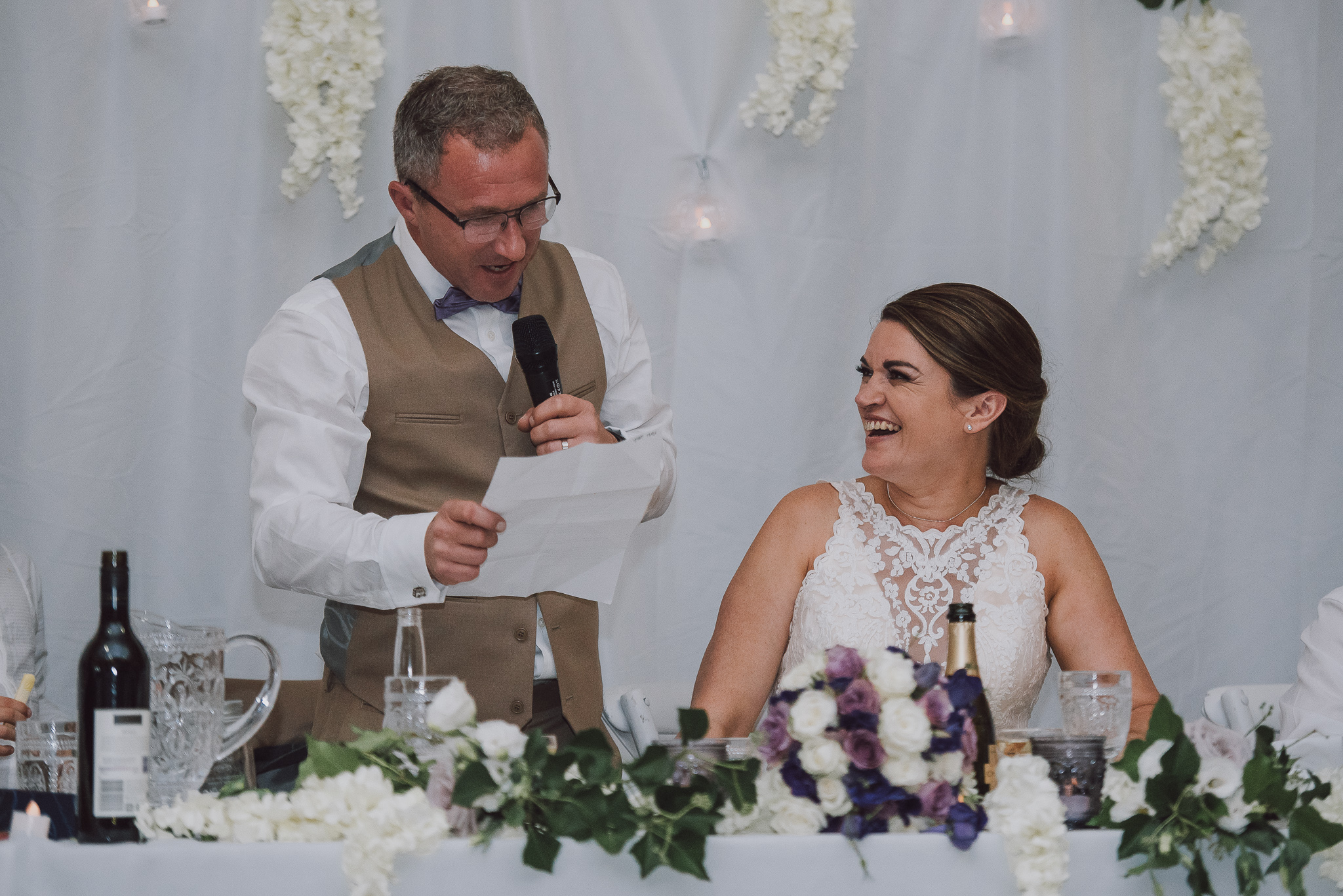 groom gives his speech next to bride