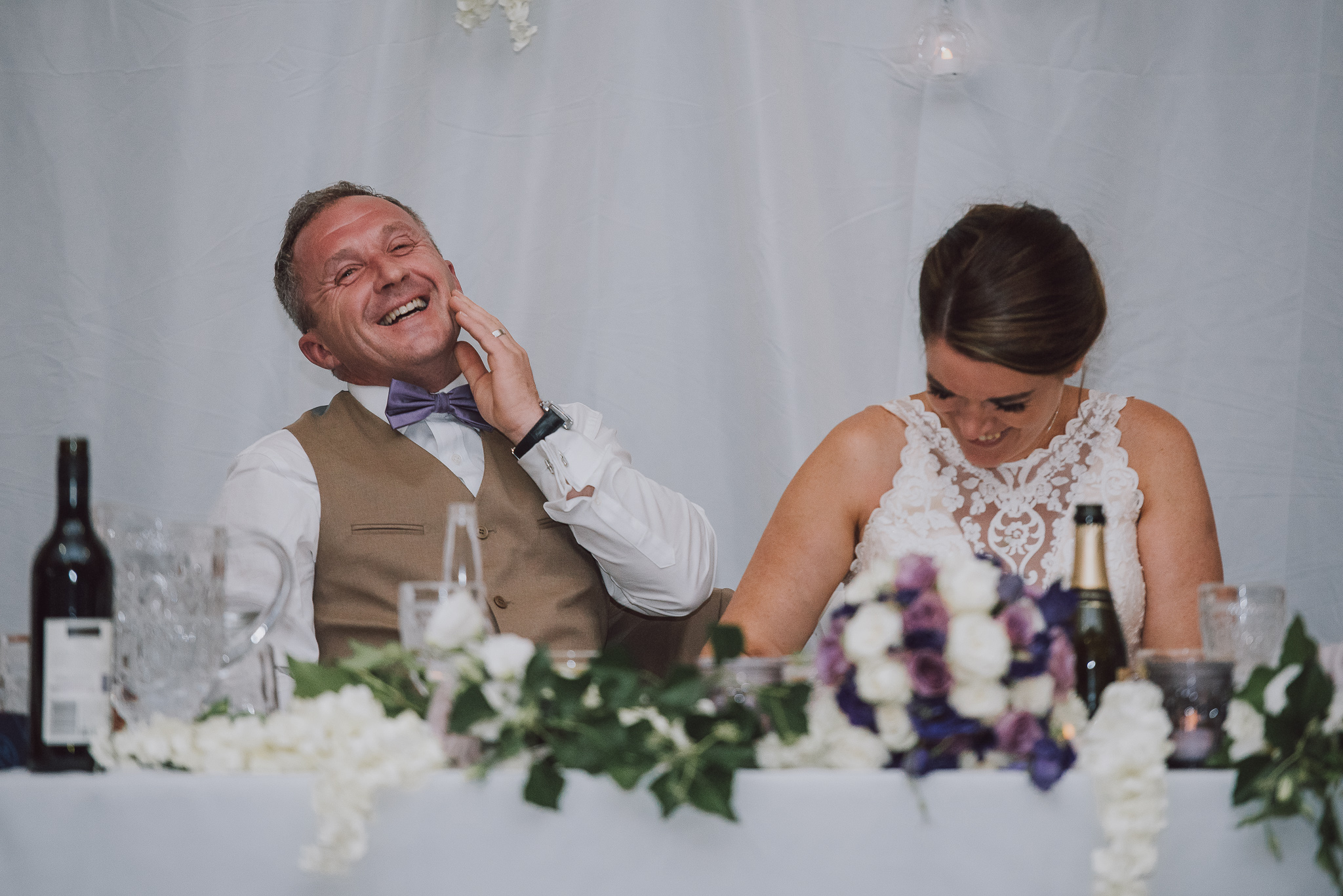 bride and groom laughing during speeches