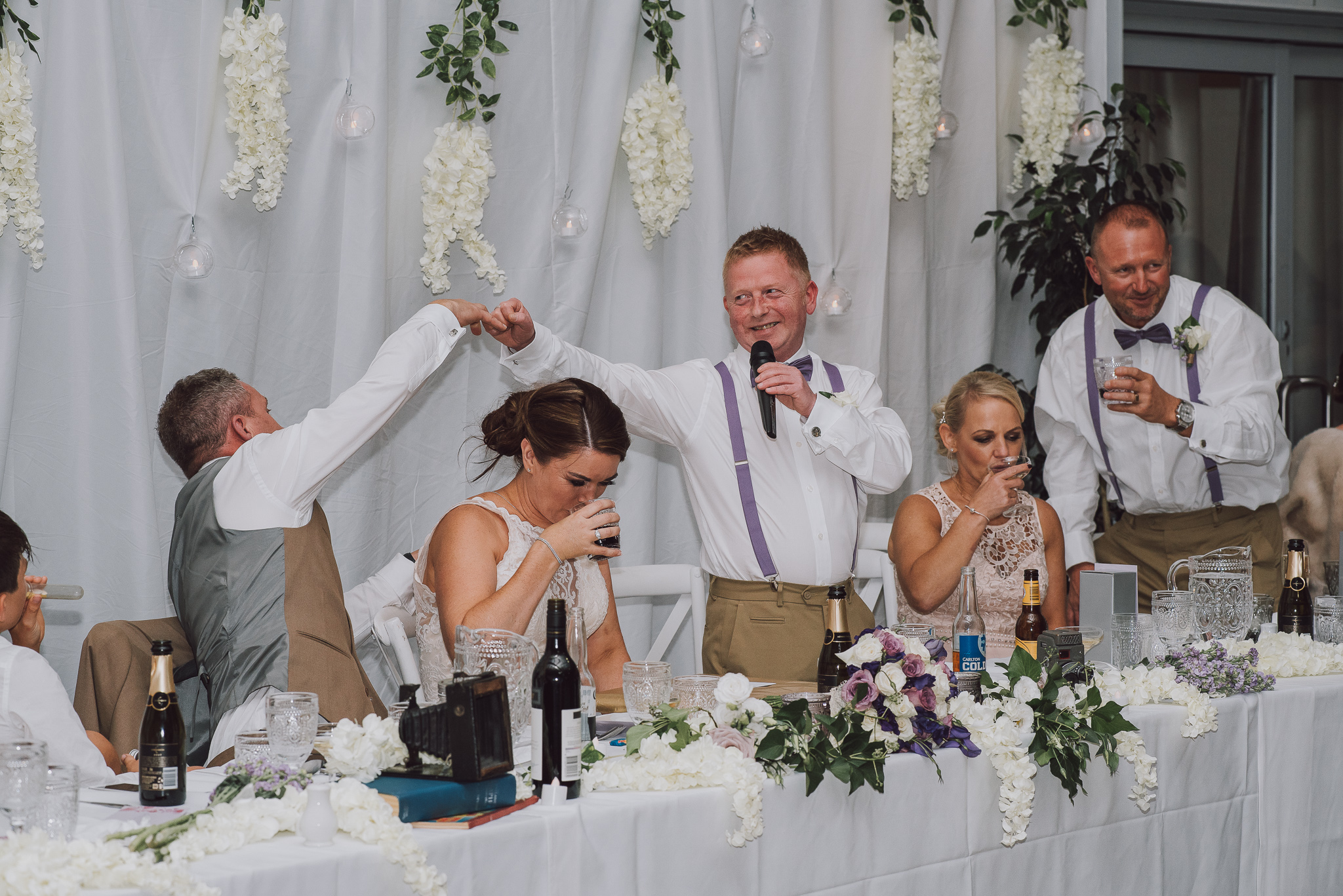 bestman and groom fist pump during his speech