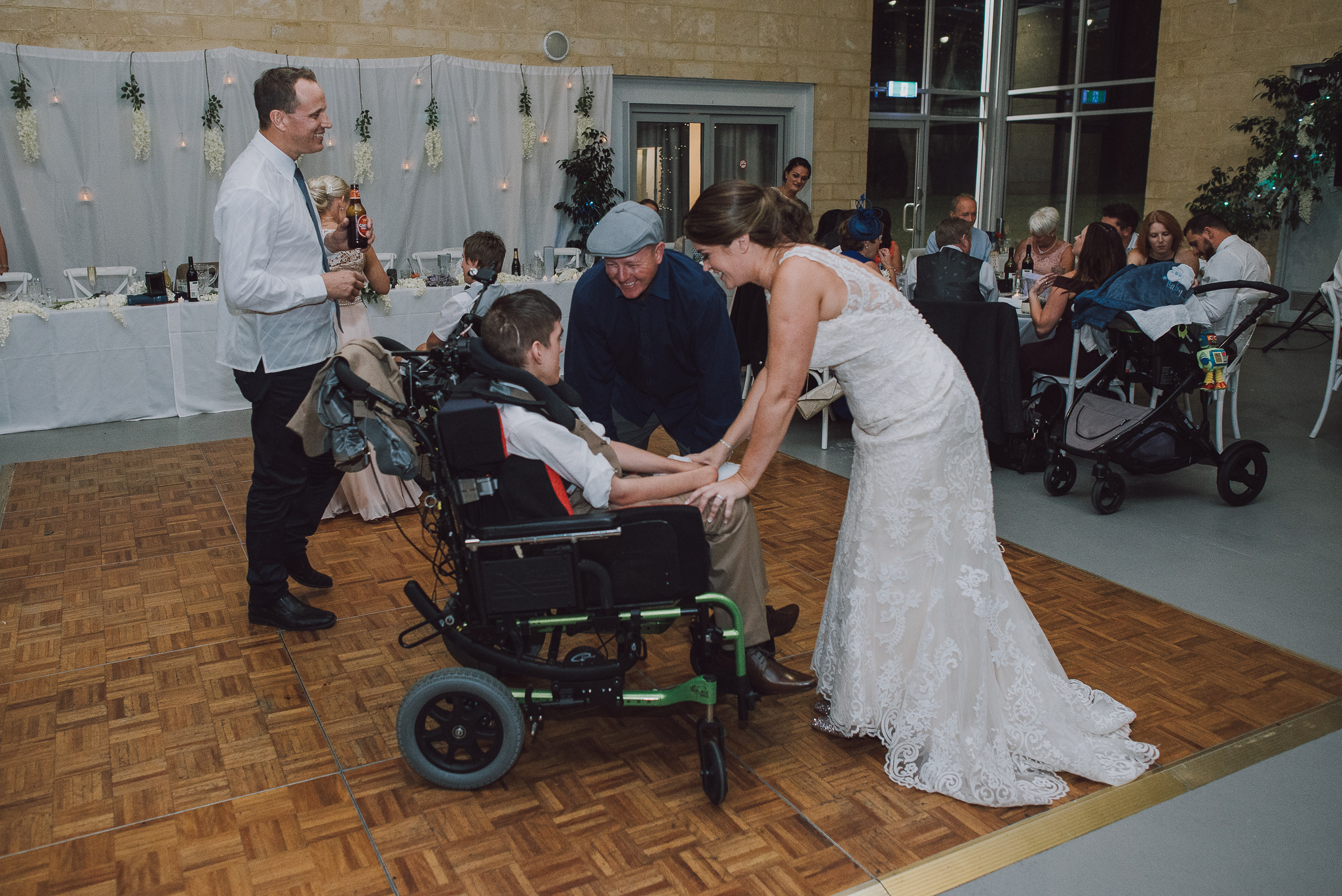 family laughing and dancing with son in wheelchair