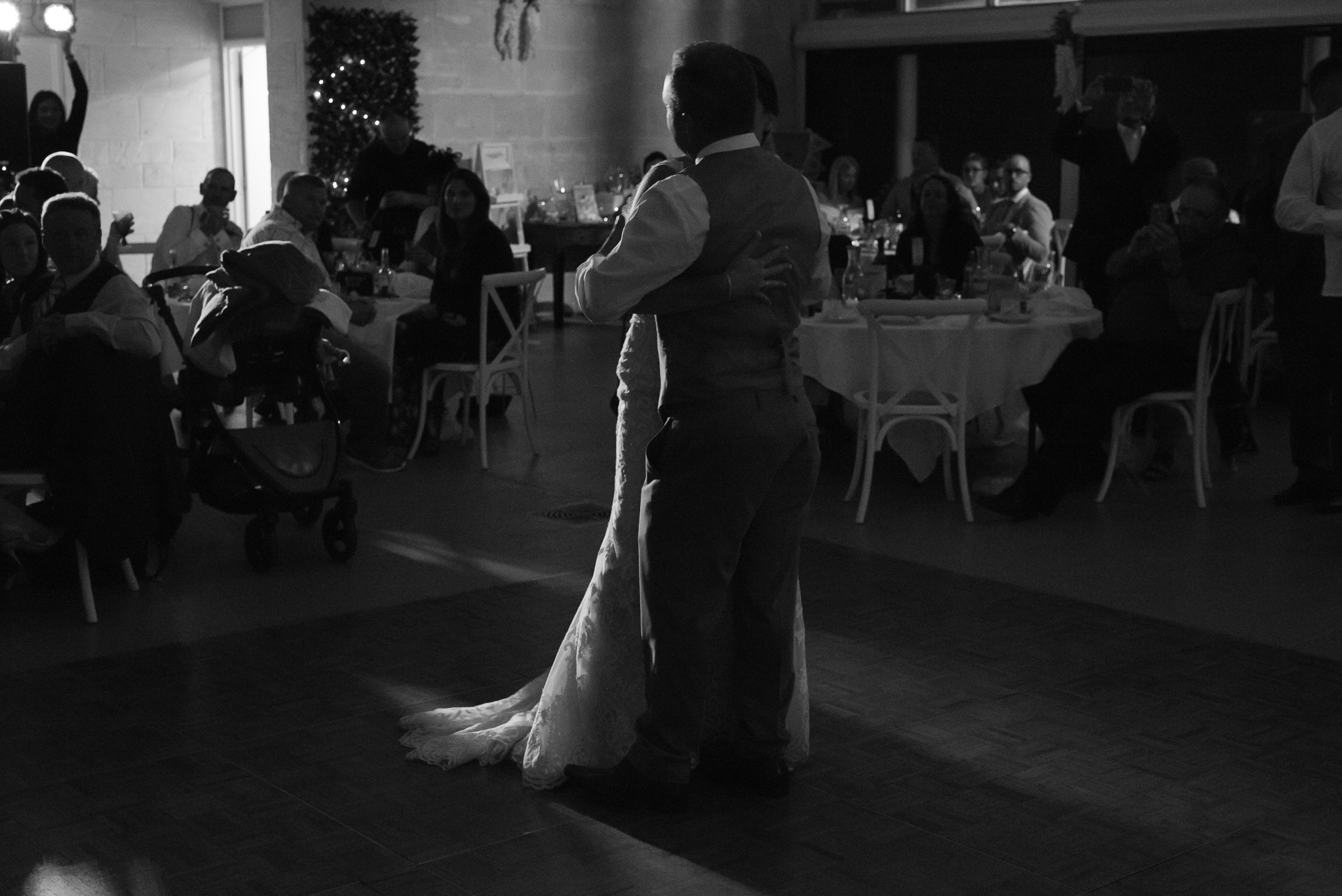 moody side lit bride and groom first dance