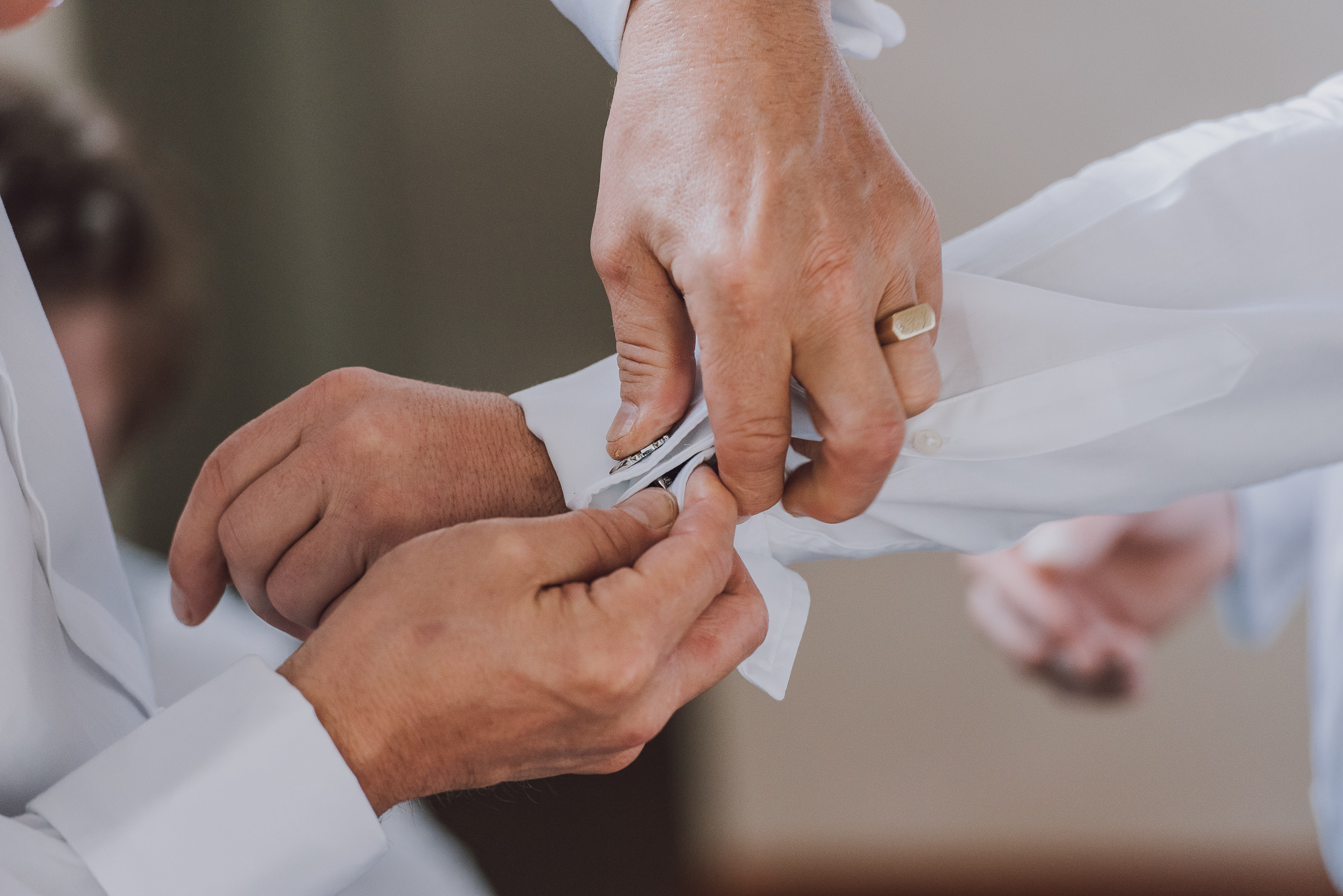 Groom has his cufflinks put on