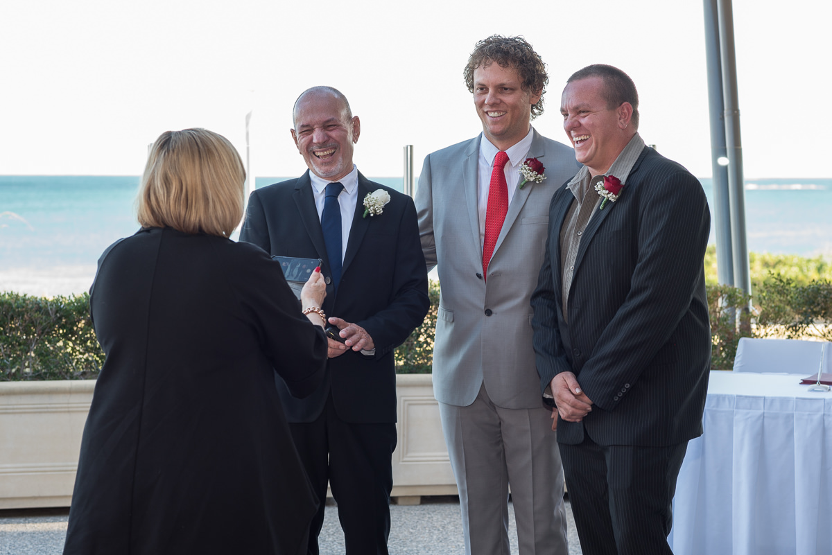 Groom and groomsmen with the celebrant at wedding