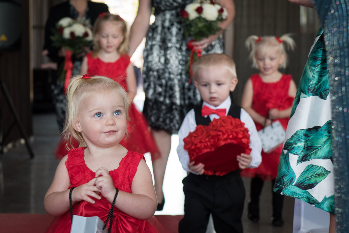 Cute flower-girl walking down the aisle at Portofinos