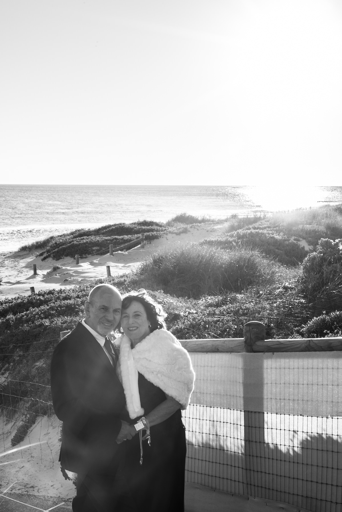 Black and white photo of older wedding couple at the beach