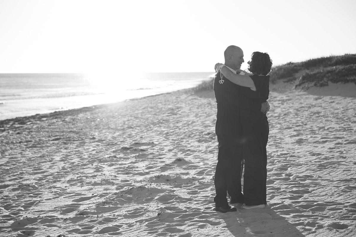 Older wedding couple hugging on Mindarie beach