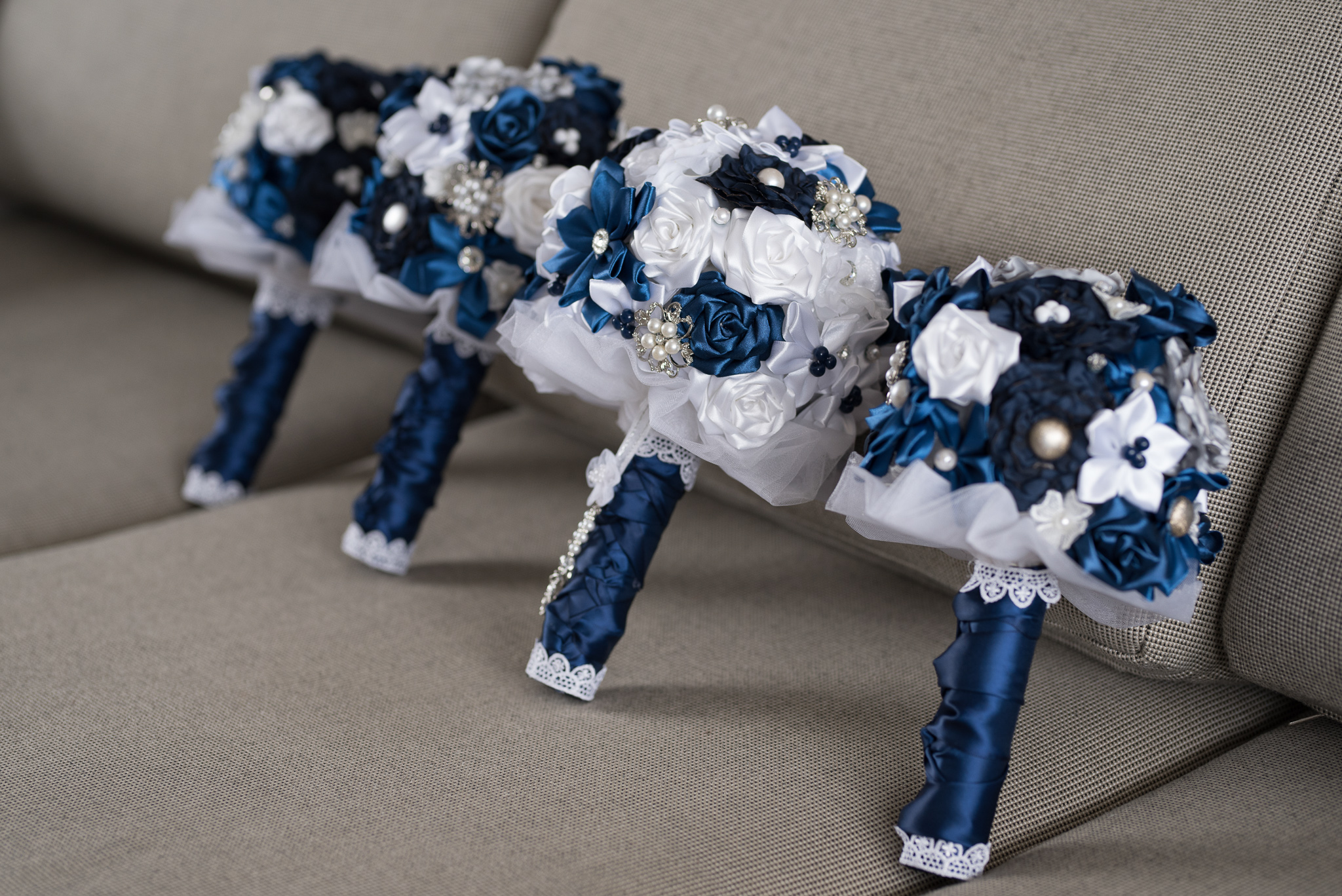 blue and white artificial wedding bouquets lined up on a lounge