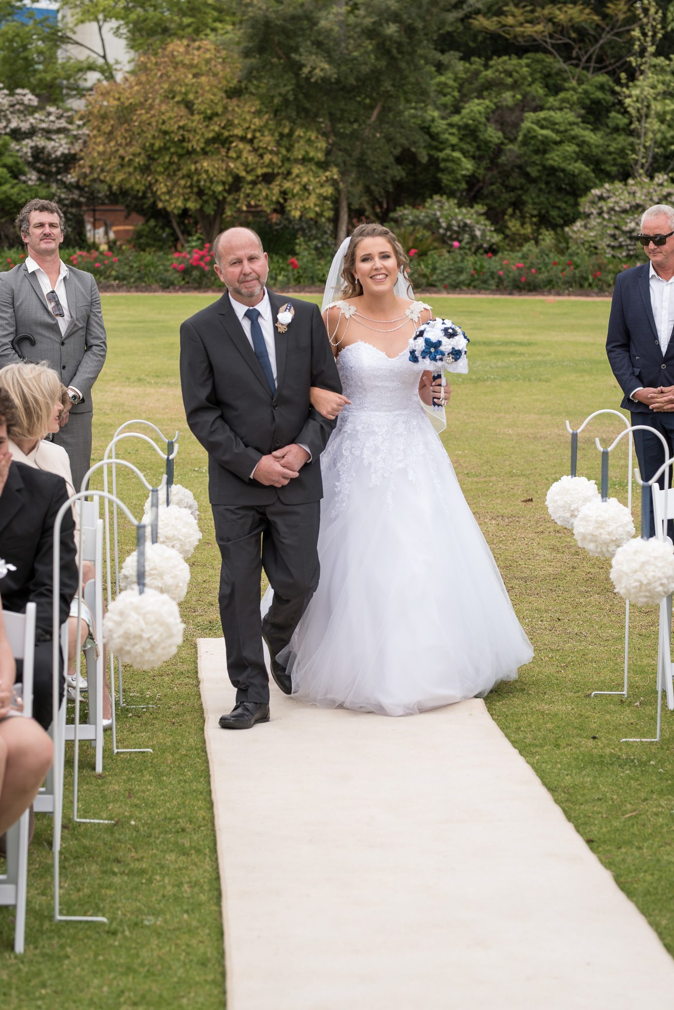 bride walks down the aisle with her dad