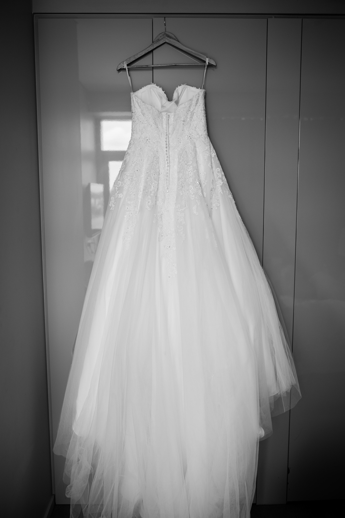 wedding dress hanging on hanger