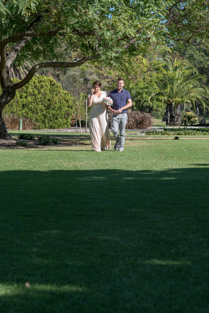 Bride walking to the wedding at Queens gardens