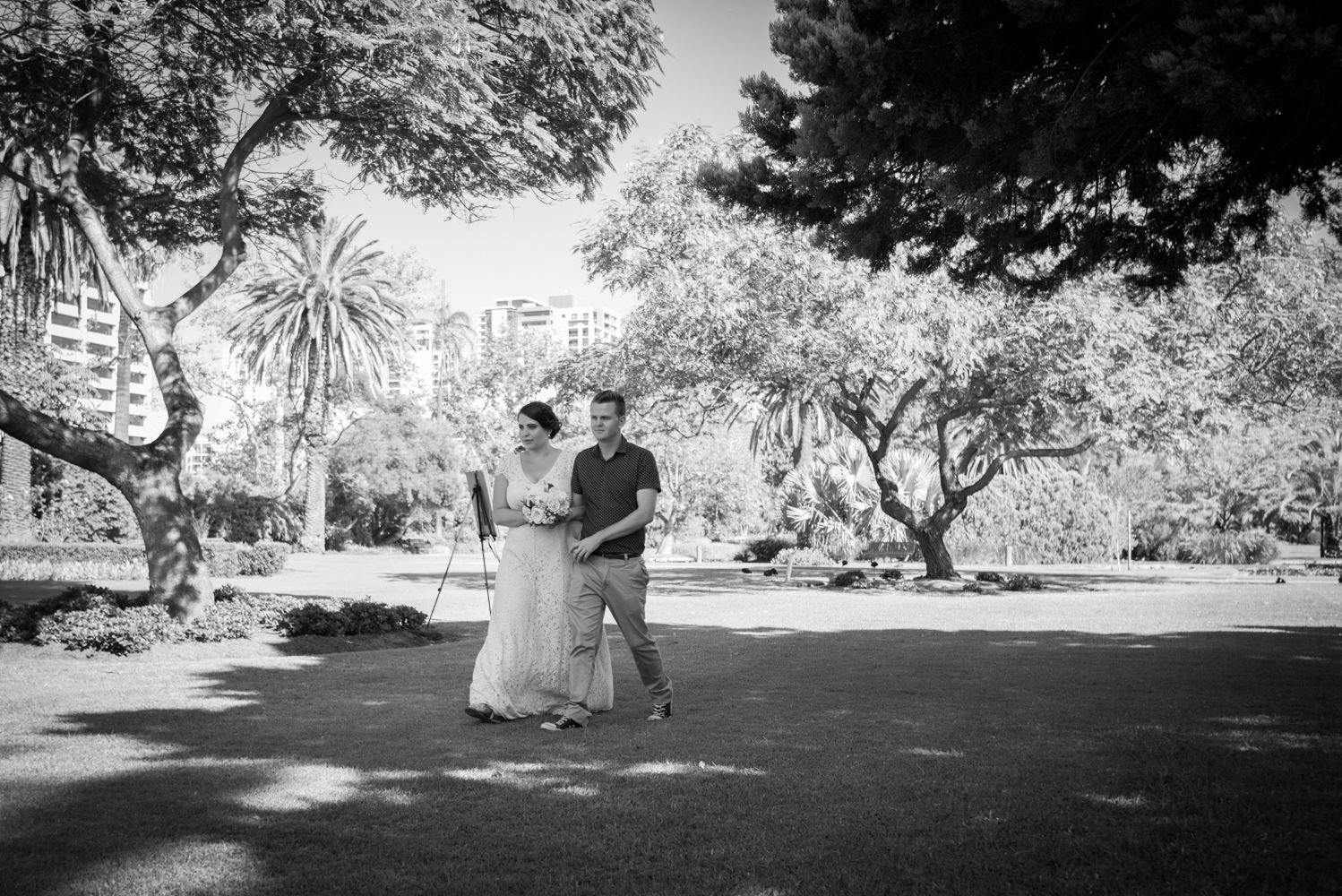 Bride walking to the wedding across the grass