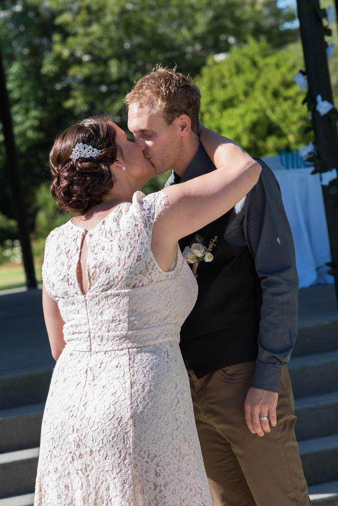 Bride and groom kiss during ceremony