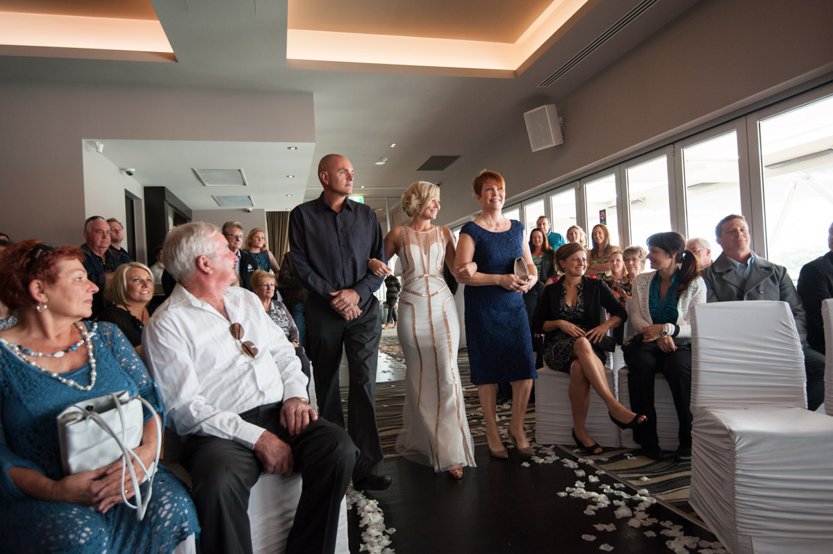 Bride walking with parents down the aisle, Breakwater