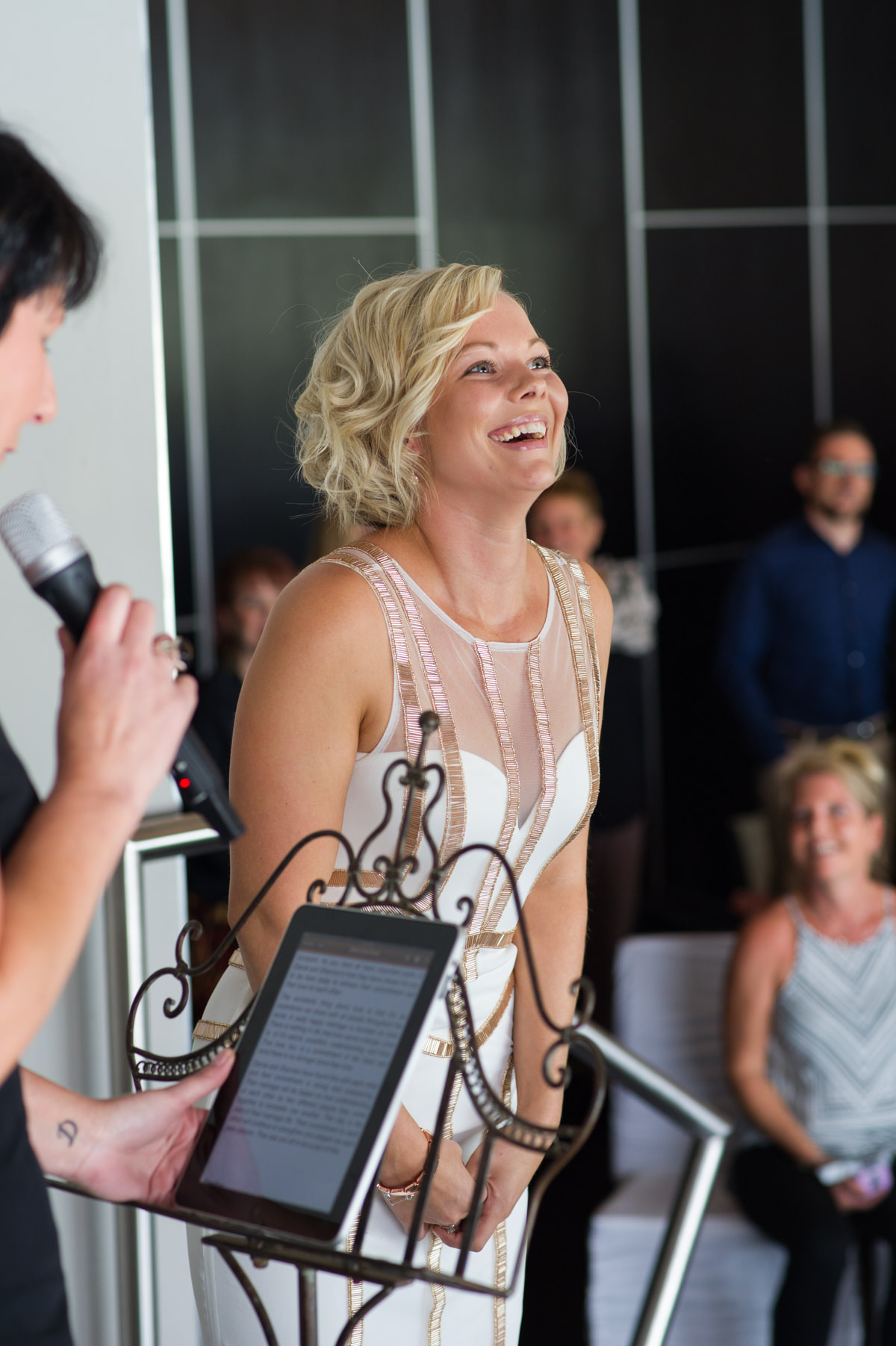 Bride laughing during ceremony at Breakwater wedding