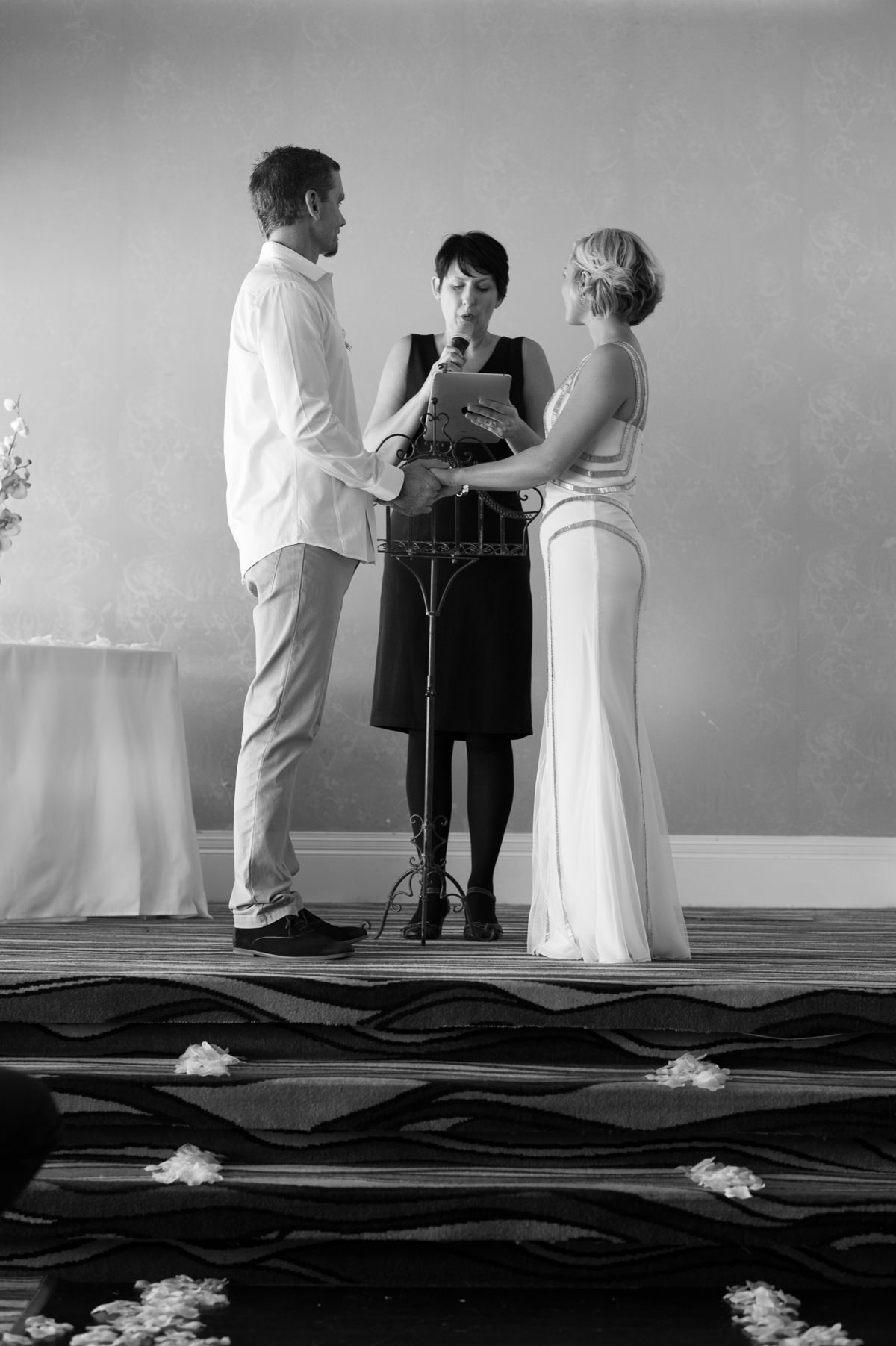 Bride and groom hold hands during ceremony