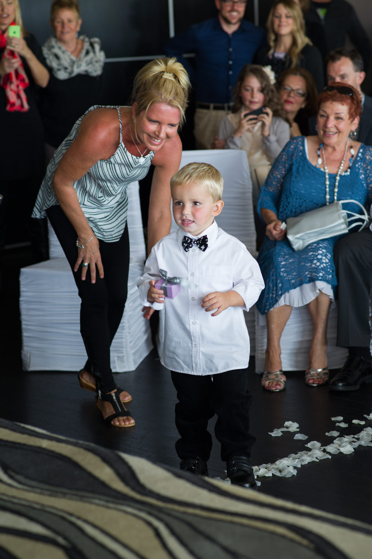 Little boy gives rings to the groom