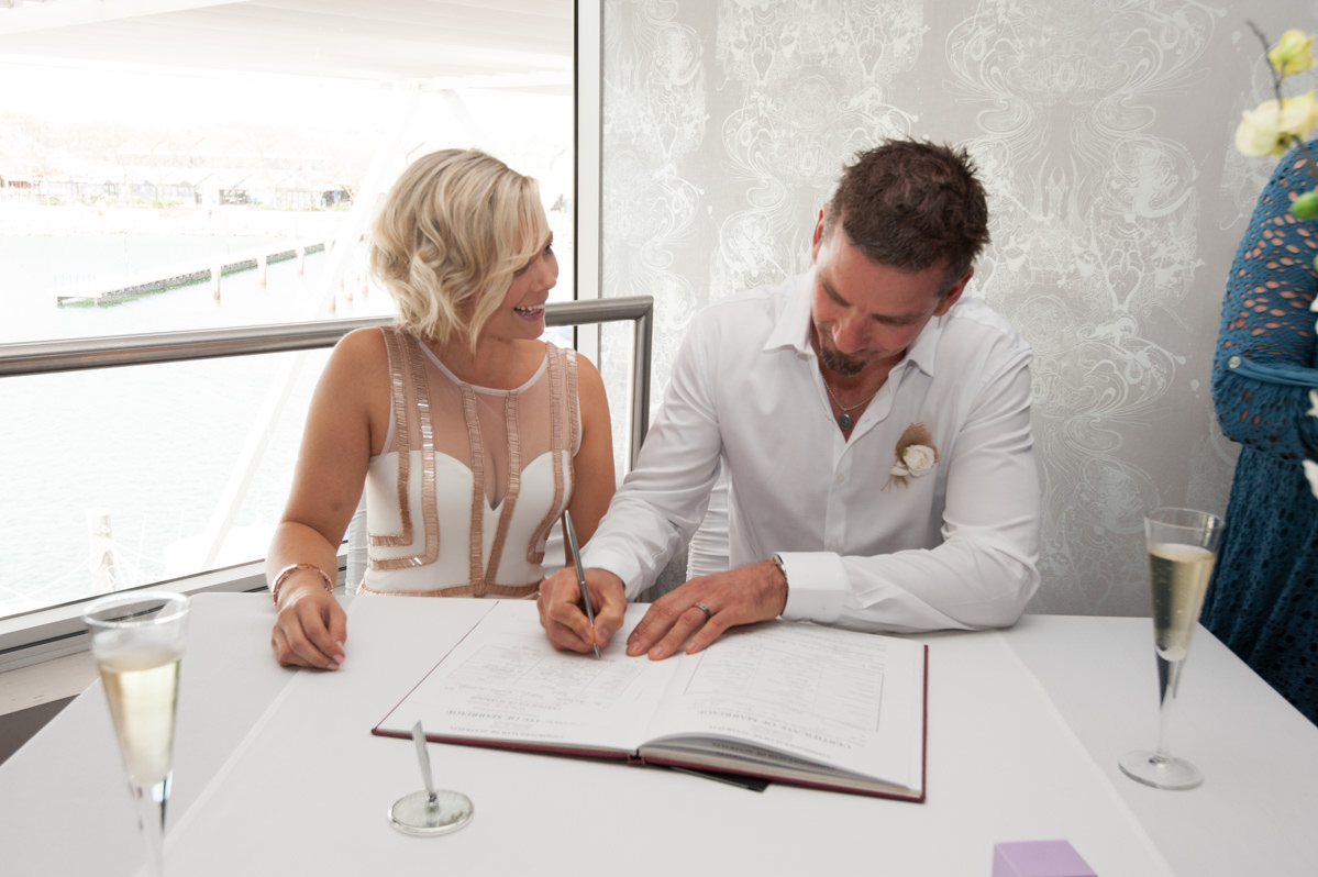 Bride and groom signing the documents