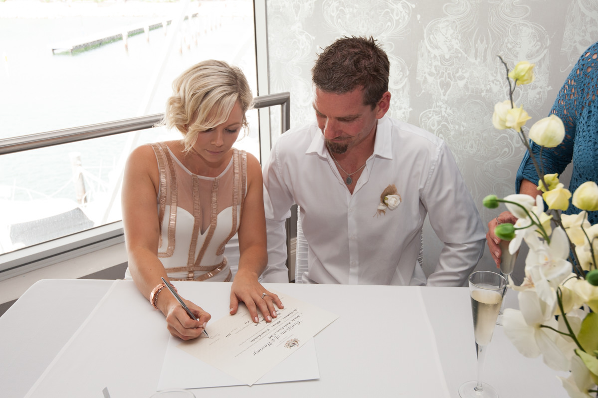 Bride signs the documents