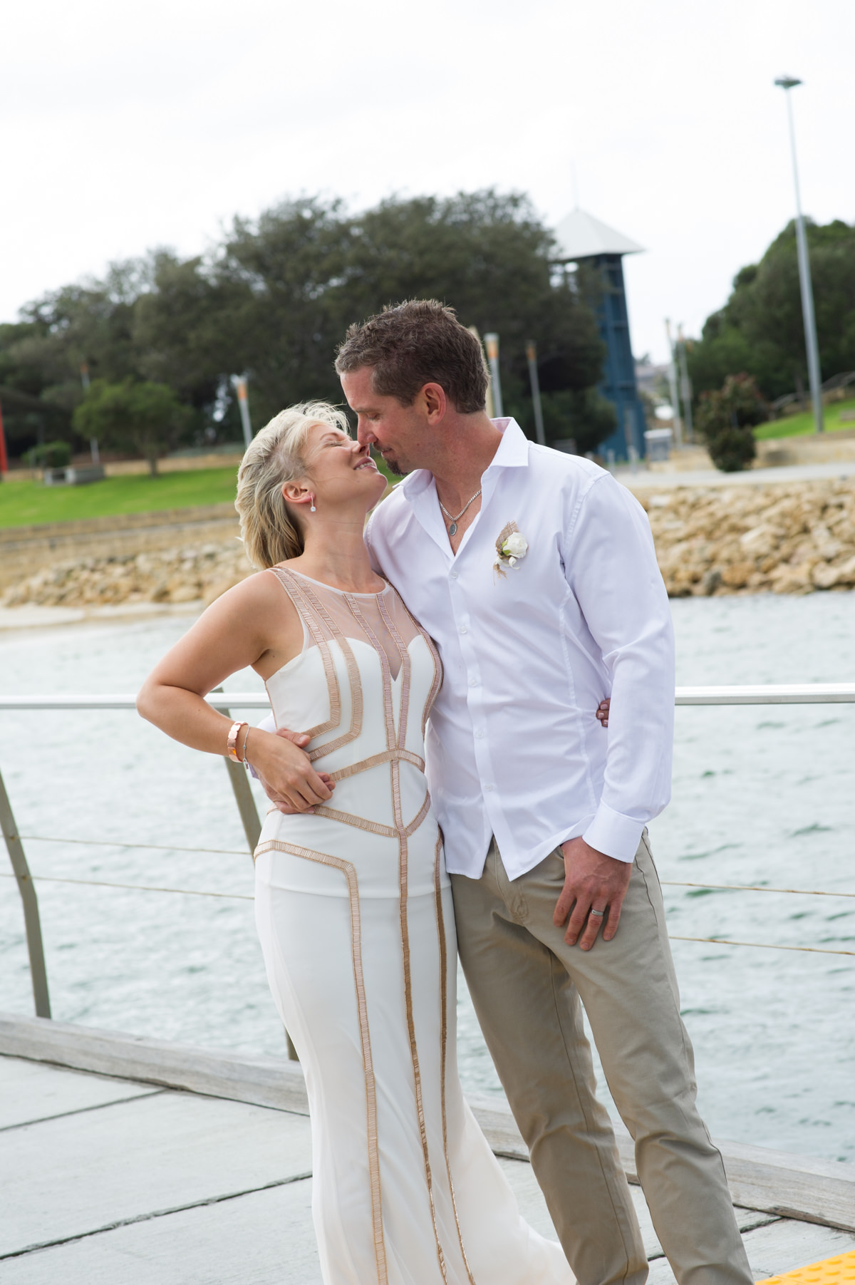 Bride and groom portrait outside The Breakwater on a windy day