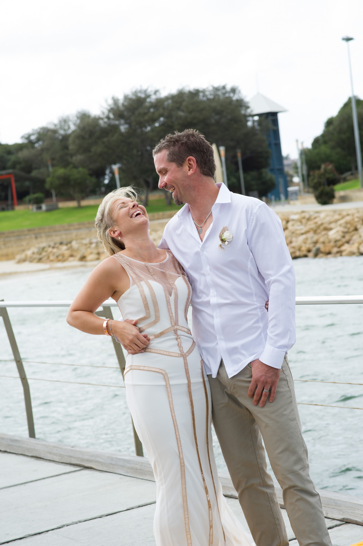 Bride and groom laughing outside The Breakwater