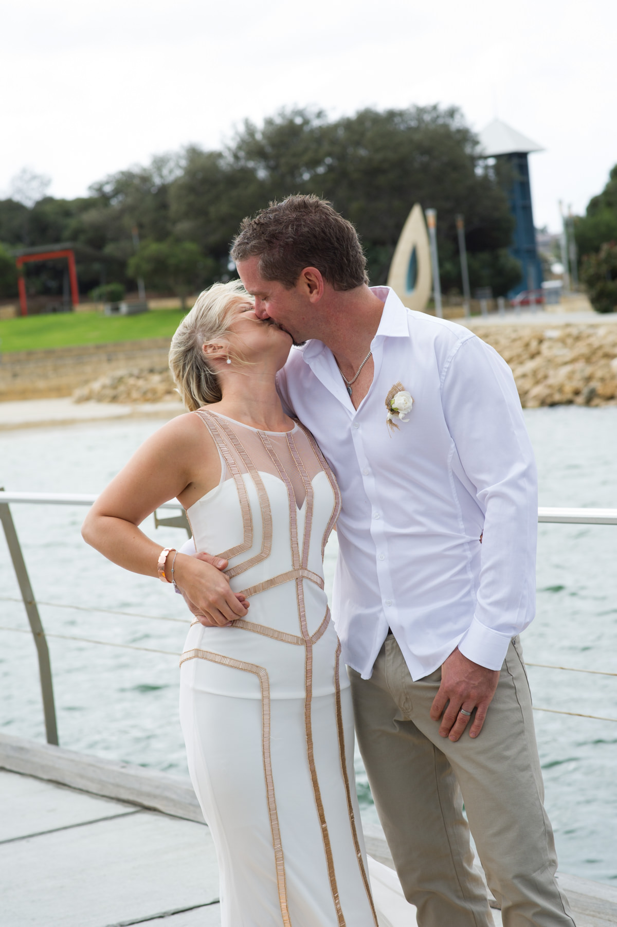 Bride and groom kiss outside The Breakwater