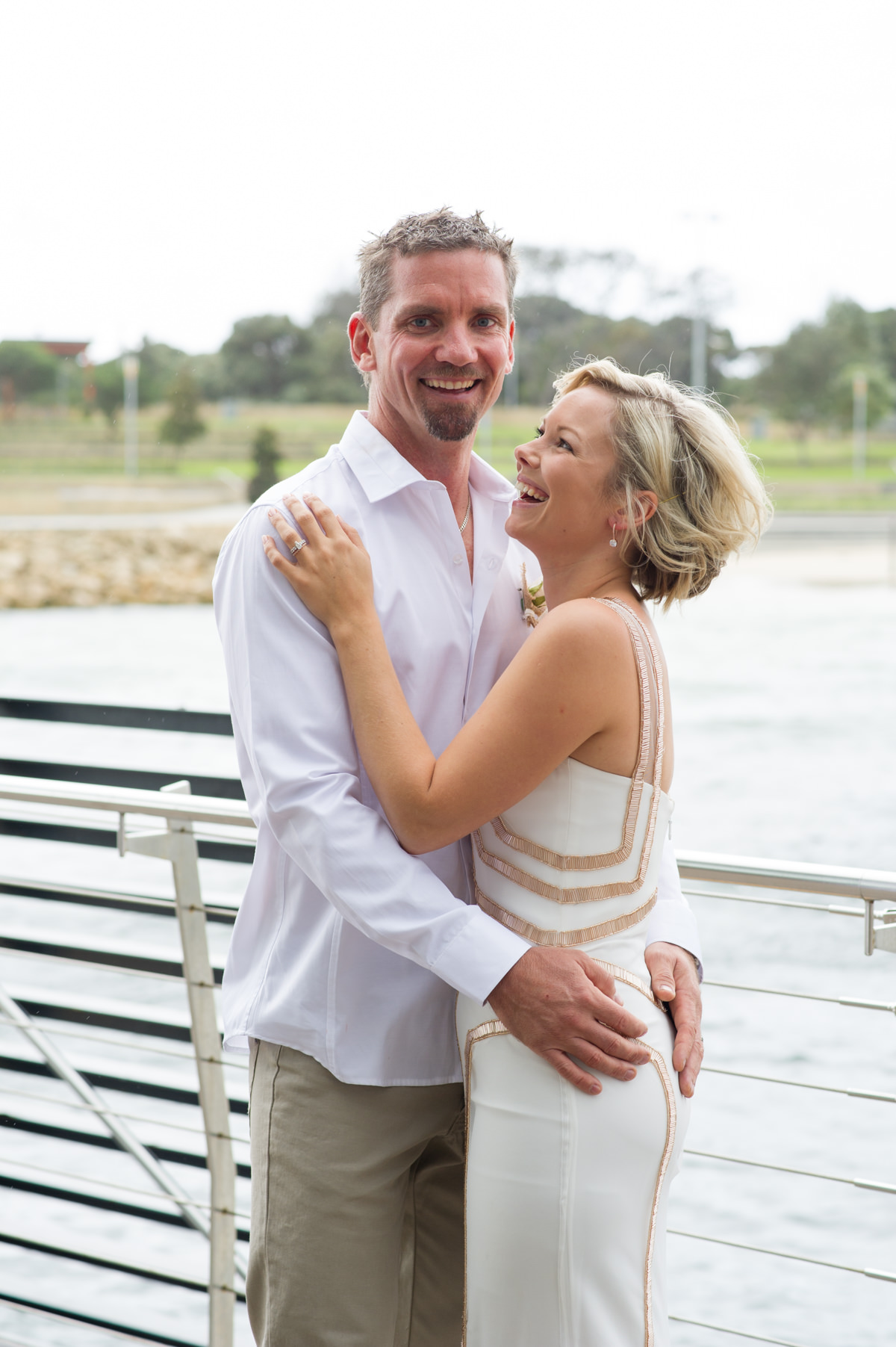 Bride looks at groom cuddling