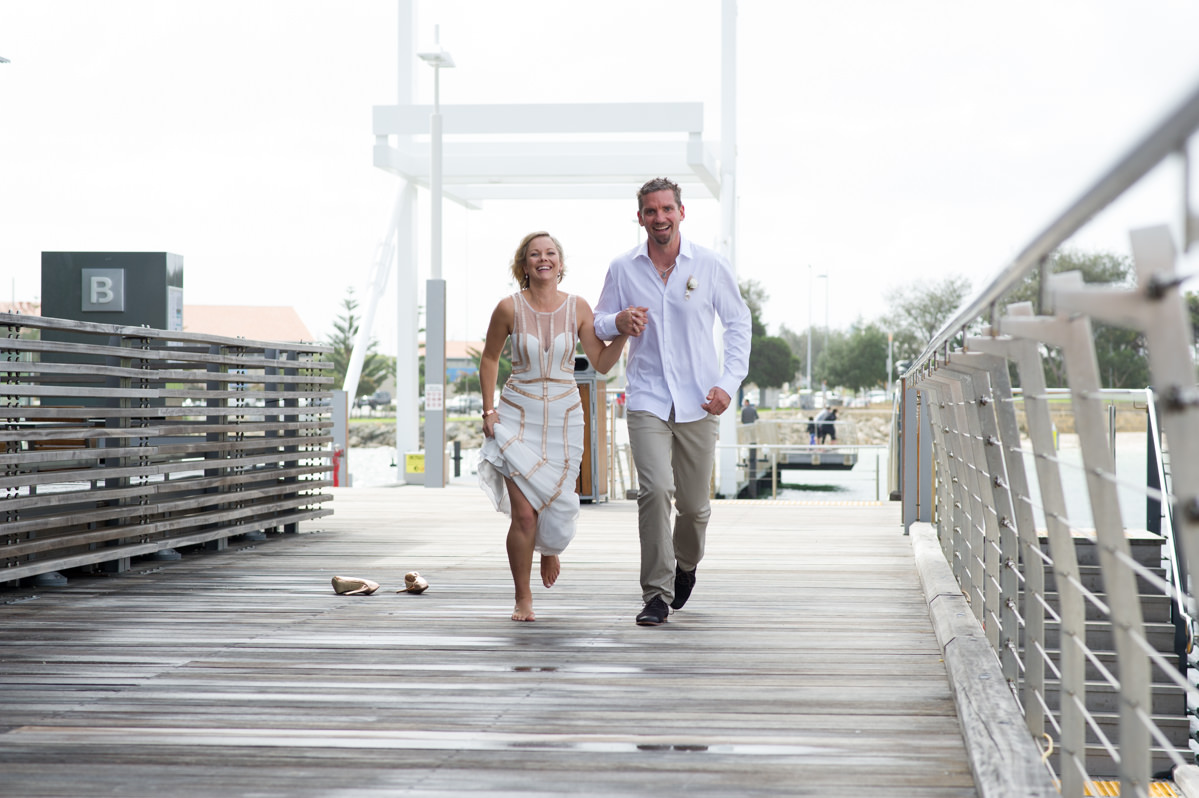 Bride and groom skipping at The Breakwater