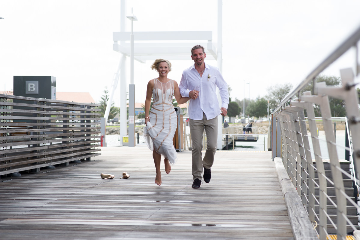 Bride and groom skipping smiling