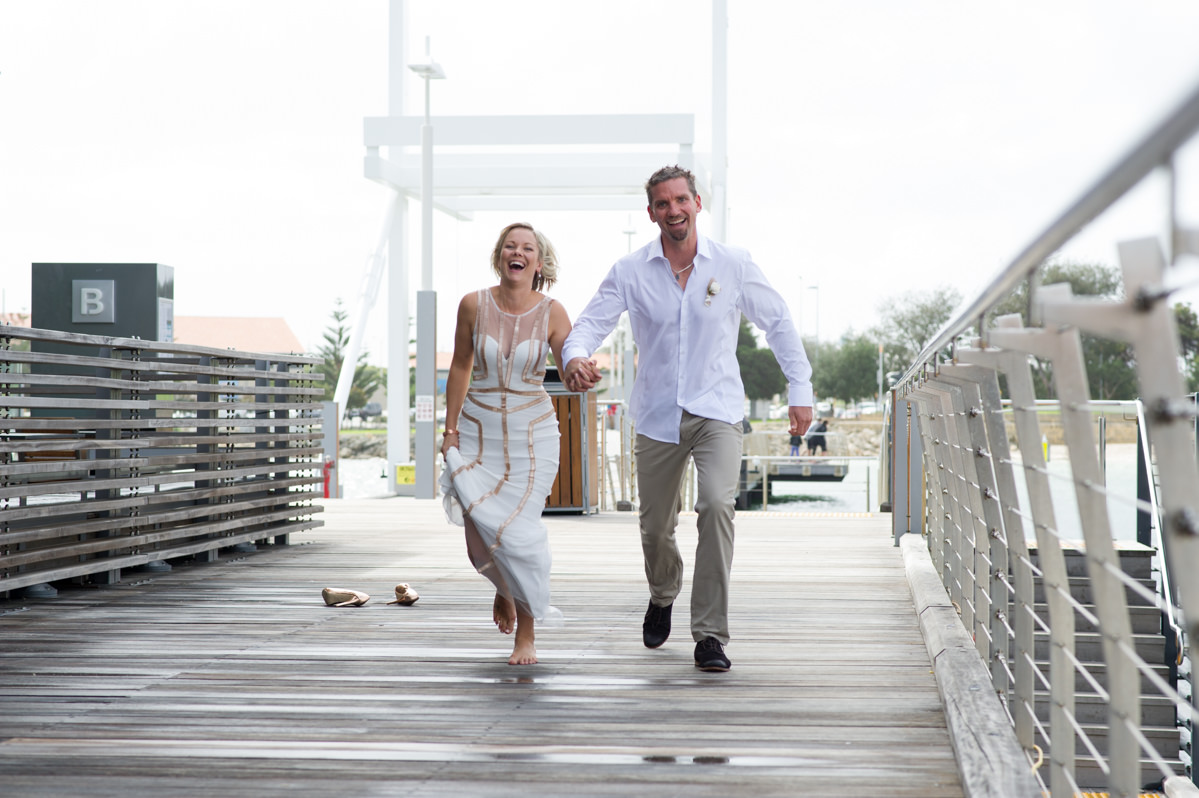 Bride and groom skipping laughing