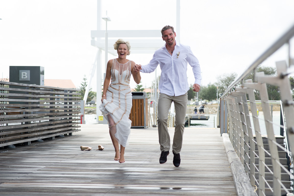 Bride and groom skipping holding hands