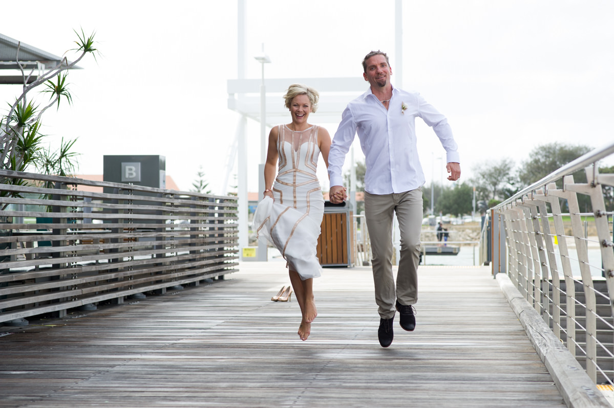 Bride and groom skipping in the air