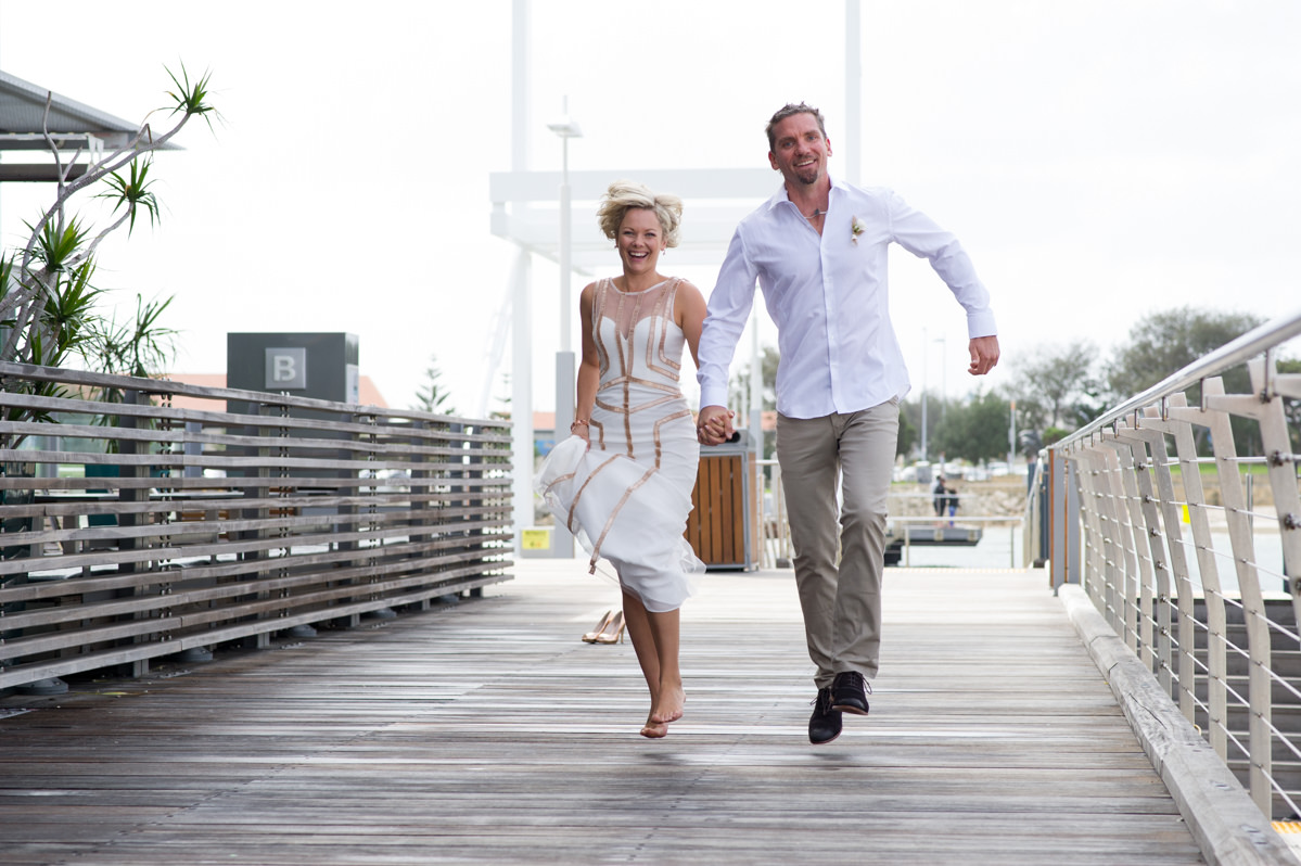 Bride and groom skipping in the air